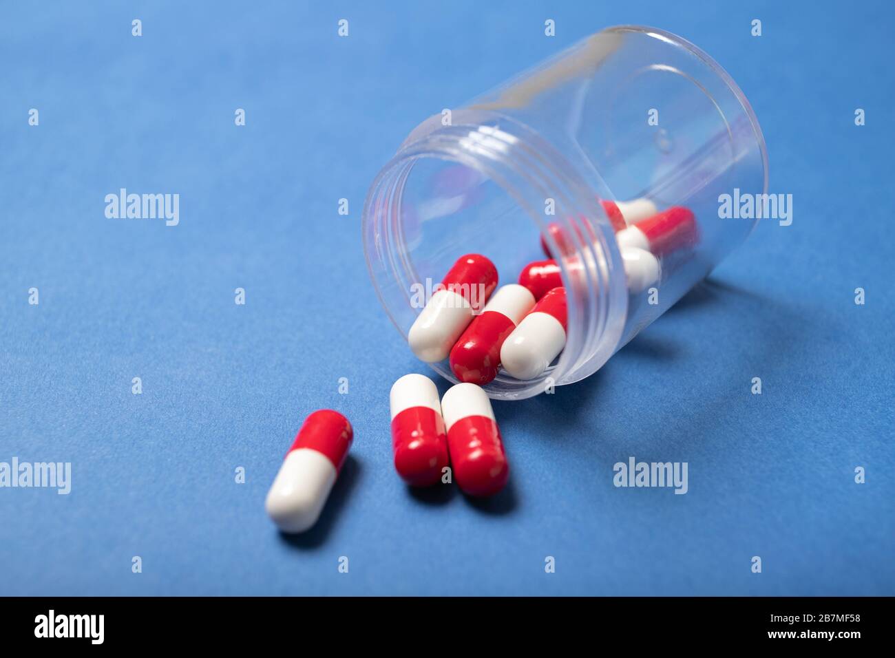 Jar with capsules on a blue background. Colds, coughing. Coronavirus. Medicine and Health Stock Photo