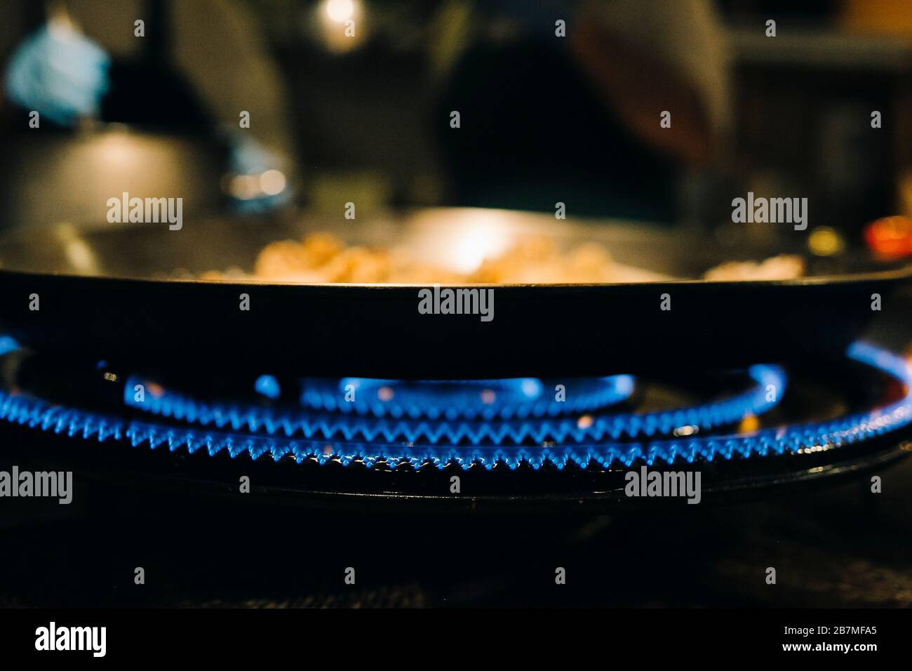 Paella on stoves while cooking Stock Photo Alamy