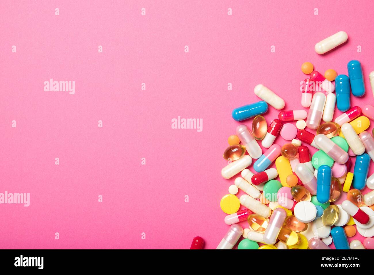 Pills and capsules on a pink background.Concept of medicine and health. Place for text Stock Photo