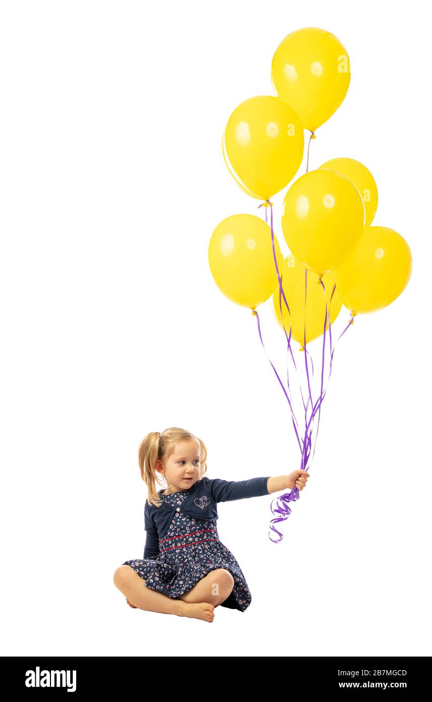 blond female child hold balloons Stock Photo