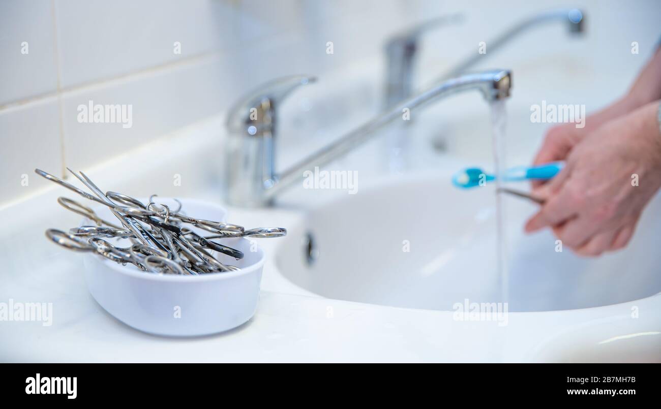 cleaning of surgical instruments in the sink after surgery Stock Photo
