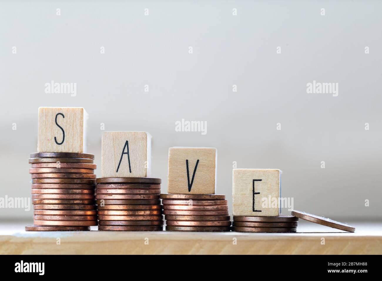 Stack of coins with save letter in wooden block, Time to Saving Concept ...