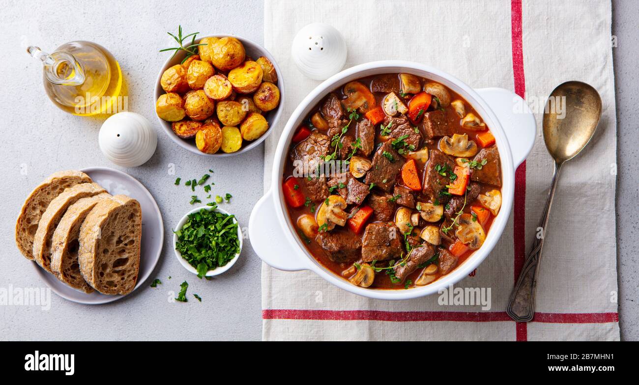 Beef bourguignon stew with vegetables. Grey background. Top view. Stock Photo