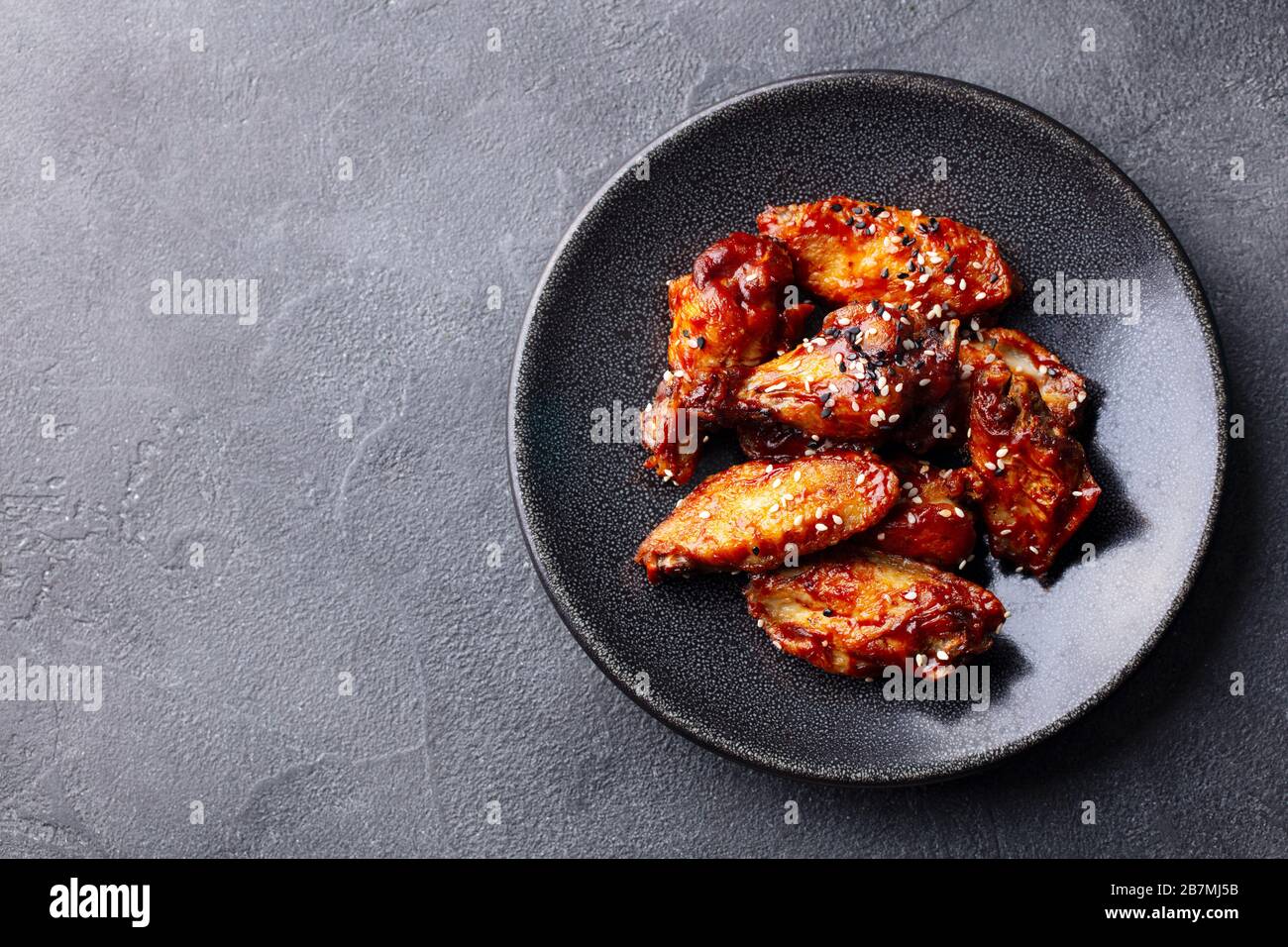 Chicken wings. Traditional asian recipe. Dark background. Copy space. Top view. Stock Photo