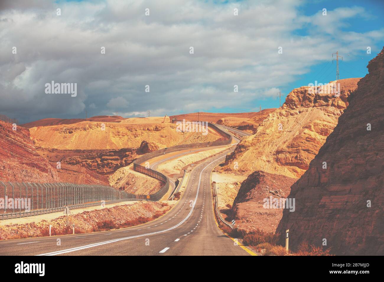 Driving a car on mountain Israel road. Desert landscape. Empty road. The road runs along the border of Israel with Egypt. View from the car of the mou Stock Photo