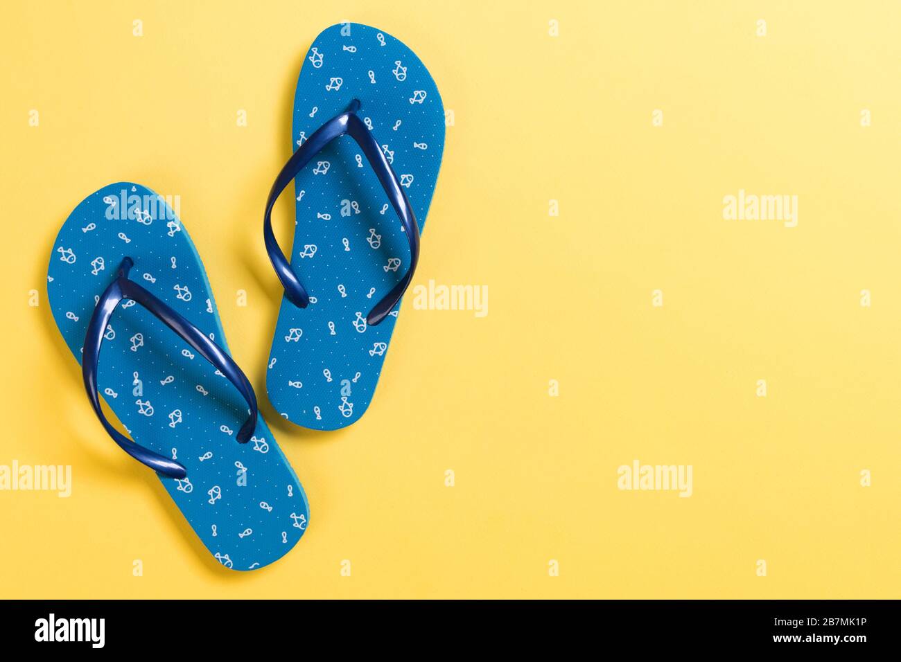 Blue flip flops on yelow Background. Top view with copy space Stock ...