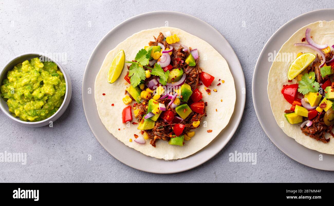 Taco with meat and vegetables. Grey background. Top view. Stock Photo