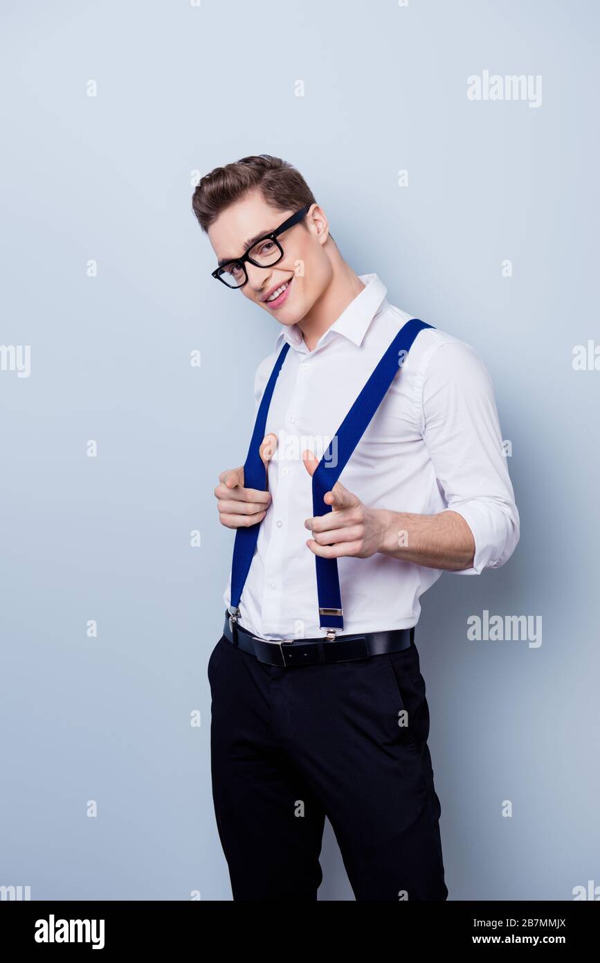 Young Handsome Macho in Formal Wear with Suspenders and in Glass