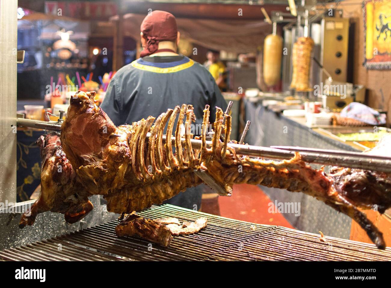 Carcass or skeleton of pig or piglet and chunks fresh hanging in the local meat market after being cooked ready to be served Stock Photo