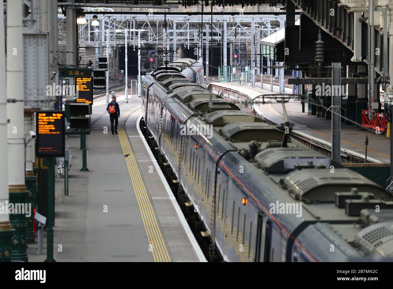 An empty looking platform at Edinburgh Waverley station, the day after Prime Minister Boris Johnson called on people to stay away from pubs, clubs and theatres, work from home if possible and avoid all non-essential contacts and travel in order to reduce the impact of the coronavirus pandemic. Stock Photo