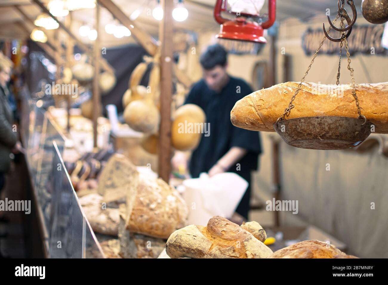 Bakers selling Hogazas, typical Spanish bread loaf, in a bakery stall