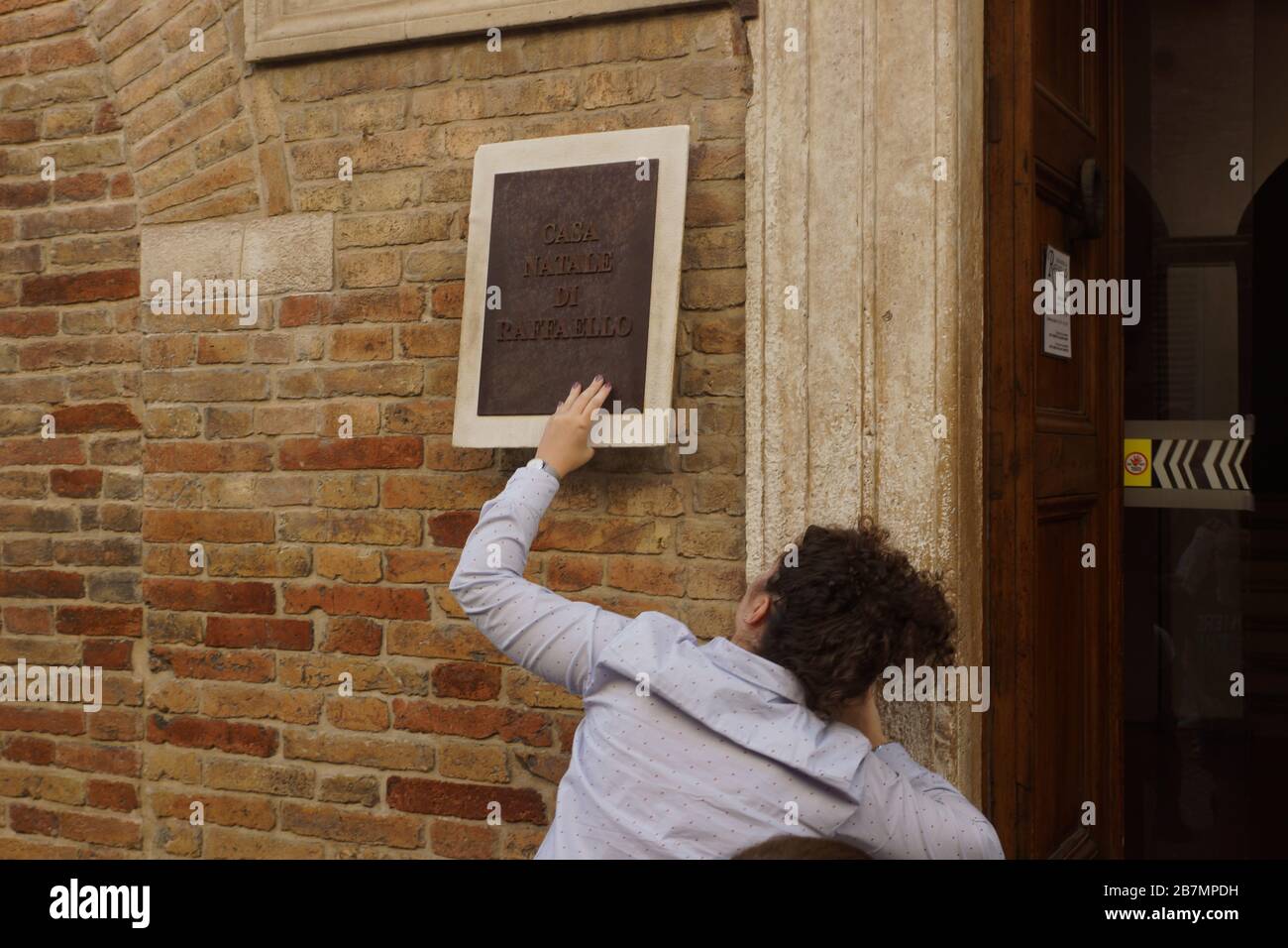 An employee of the museum hangs a sign each time so that students do not carry it away. Raphael's house-museum (Raffaello Santi)  in Urbino. Italy Stock Photo