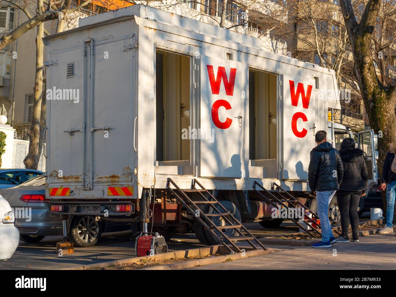 Mobile toilets truck parked in a busy street for an event in the city Stock Photo