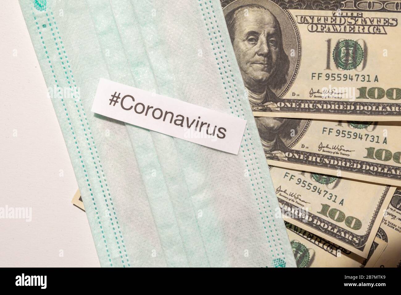 Corona virus impact on American economy concept, banknotes with medical mask and banknotes Stock Photo