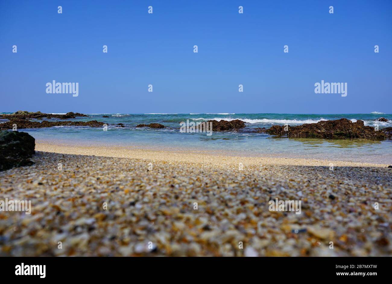 Scenic view of coconut palms and the Idian Ocean from the pristine sandy beach. The sunny beaches of Sri Lanka (such as Hikkaduwa, Mirissa, Unawatuna) Stock Photo