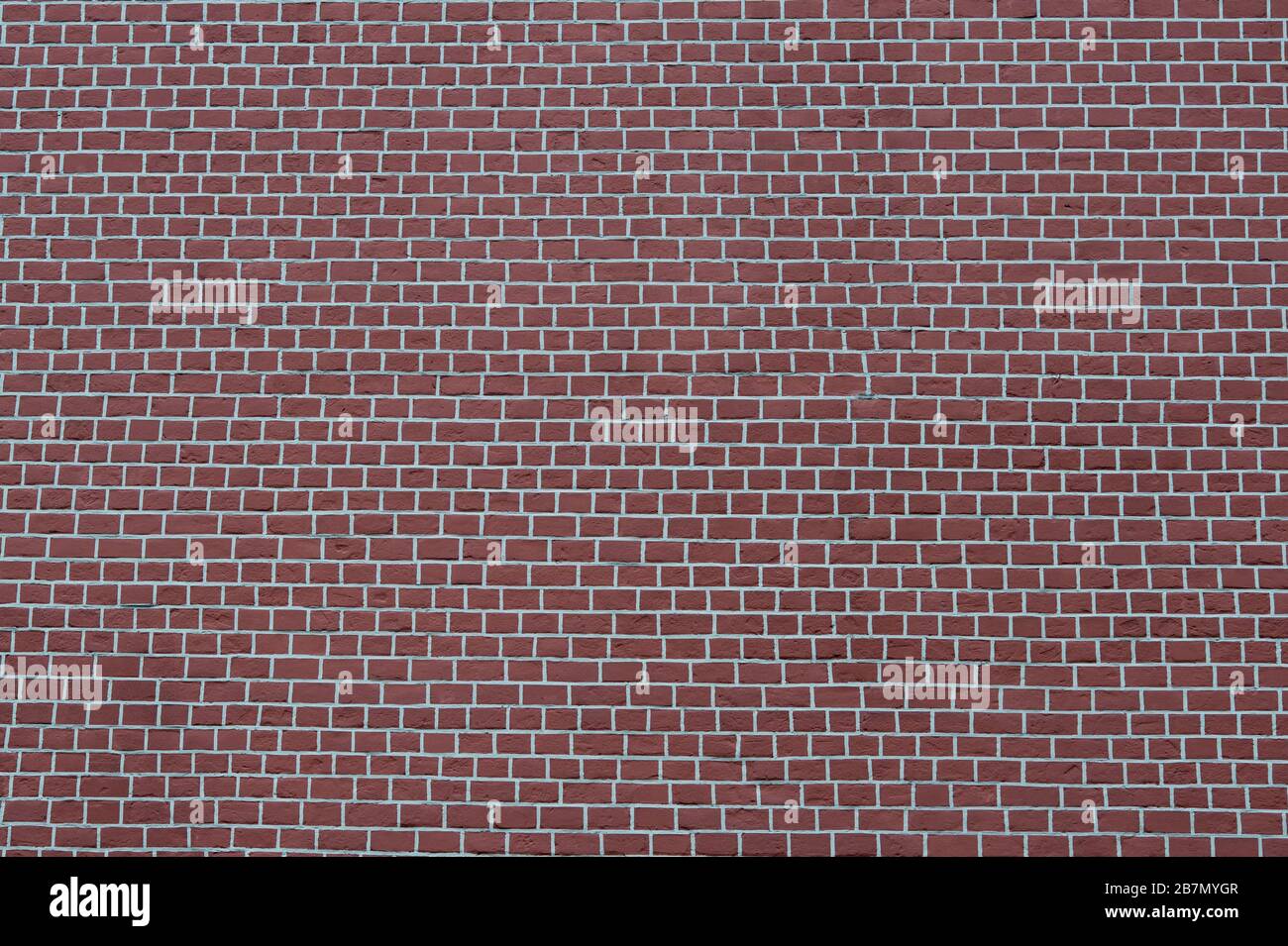 A smooth brown brick wall with white joints. Textured background. Stock Photo