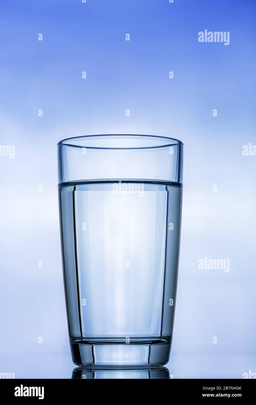 glass transparent glass with clean water against the blue sky. with reflection Stock Photo