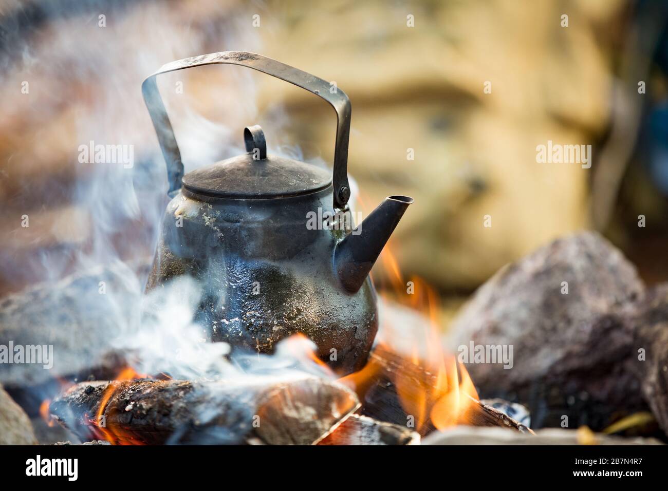 making coffee in big kettle on campfire 
