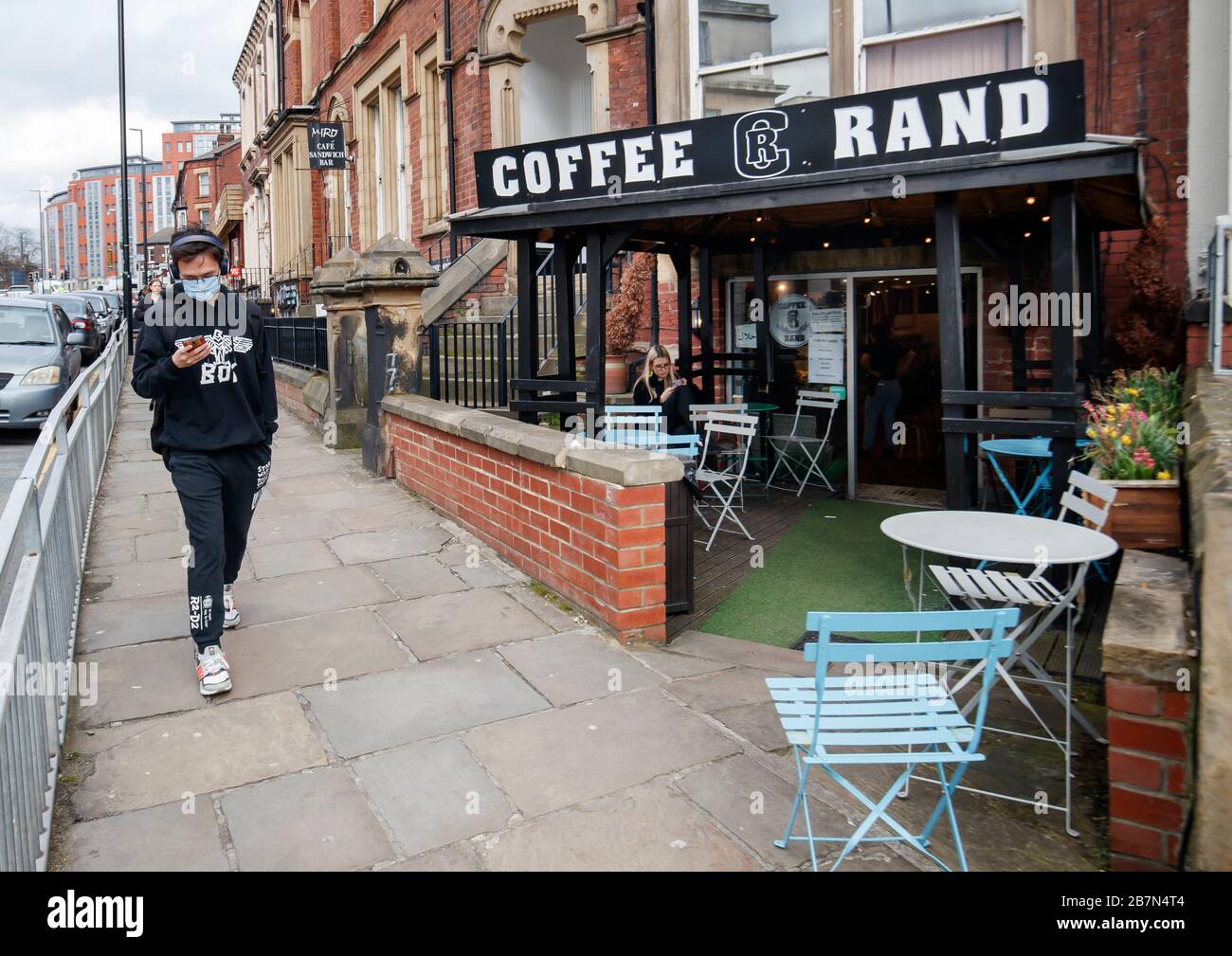 A Man Wearing A Face Mask Walks Past A Cafe In Leeds West Yorkshire The Day After Prime Minister Boris Johnson Called On People To Stay Away From Pubs Clubs And Theatres