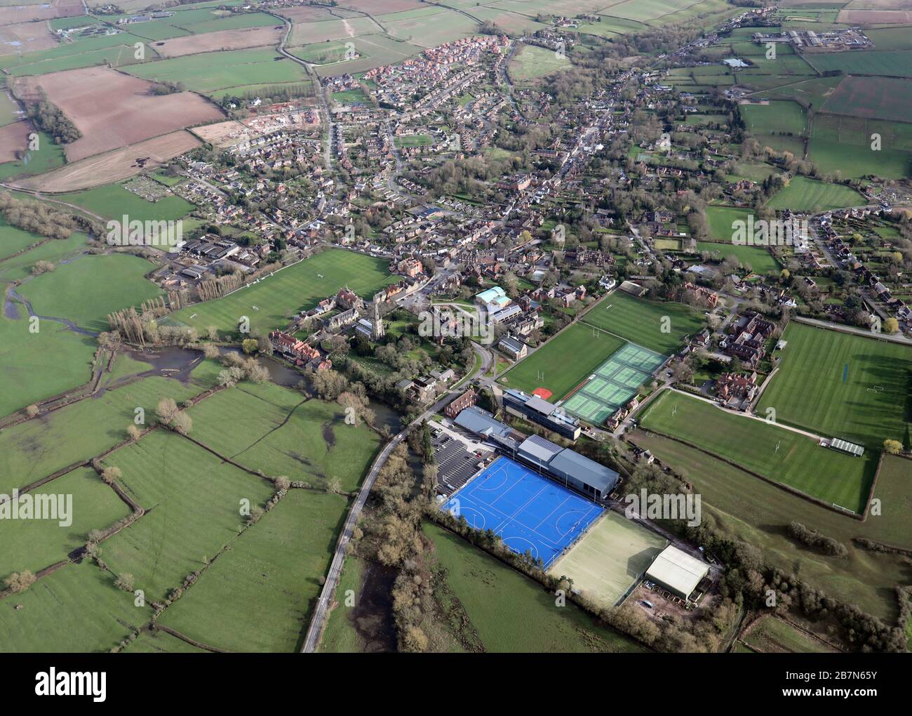 aerial view of Repton village near Derby, with Repton Hockey Club (blue pitch in foreground) & Repton School prominent Stock Photo