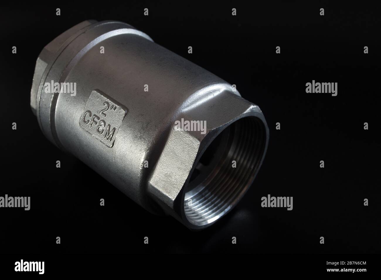 Casted stainless steel check valve 2 inch on black background Stock ...