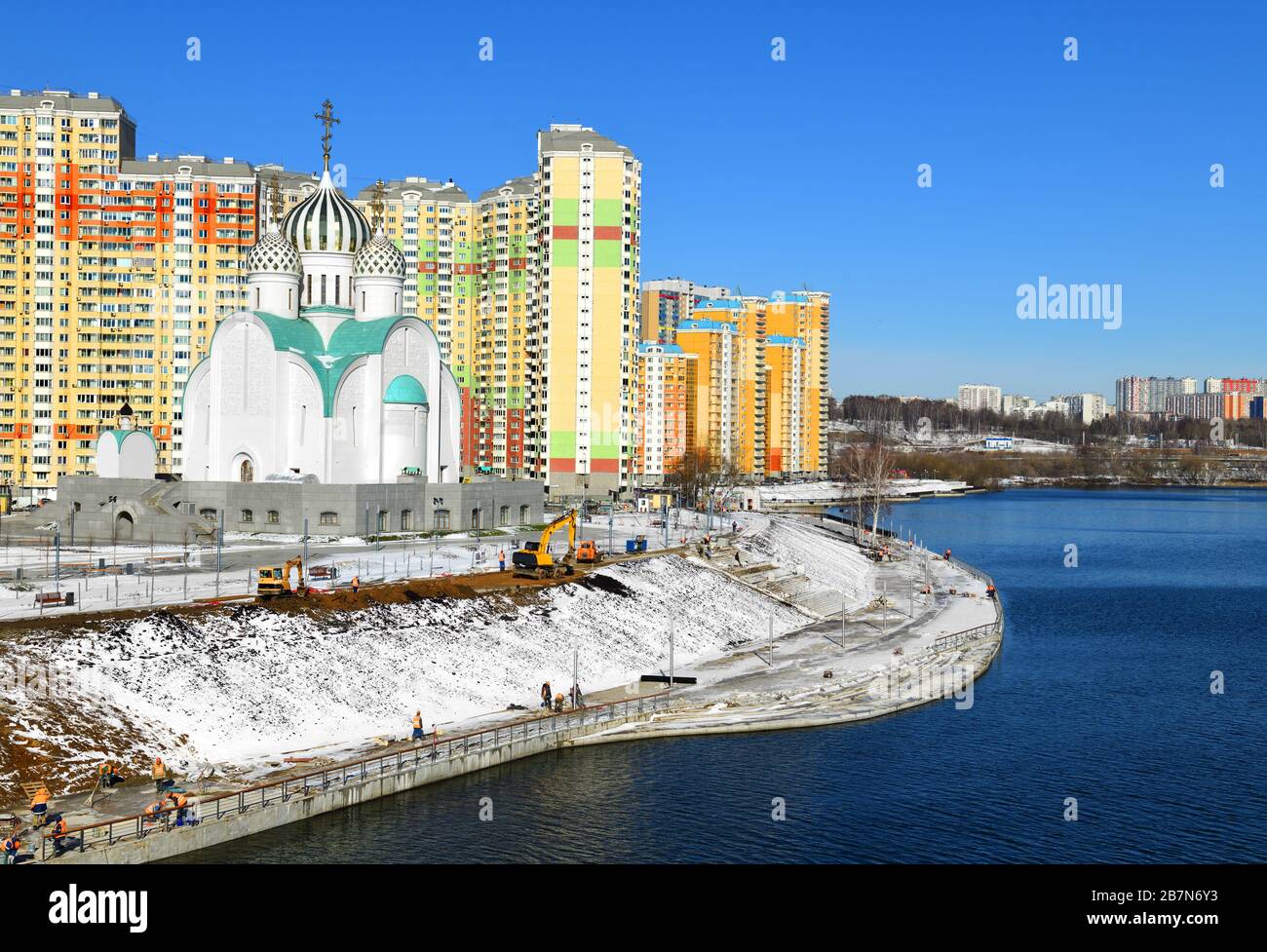 Workers are building Moscow river embankment and St. Nicholas Church in new area of Pavshinsky floodplain Stock Photo