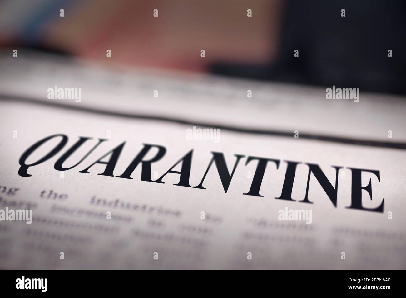Quarantine written newspaper close up shot to the text. Stock Photo