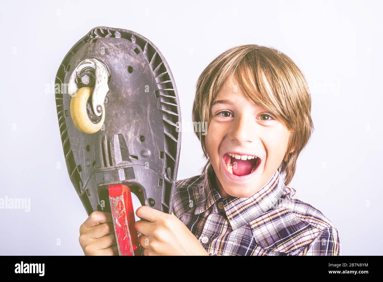 Happy pre teen boy with board. Fun and leisure lifestyle concept. Stock Photo