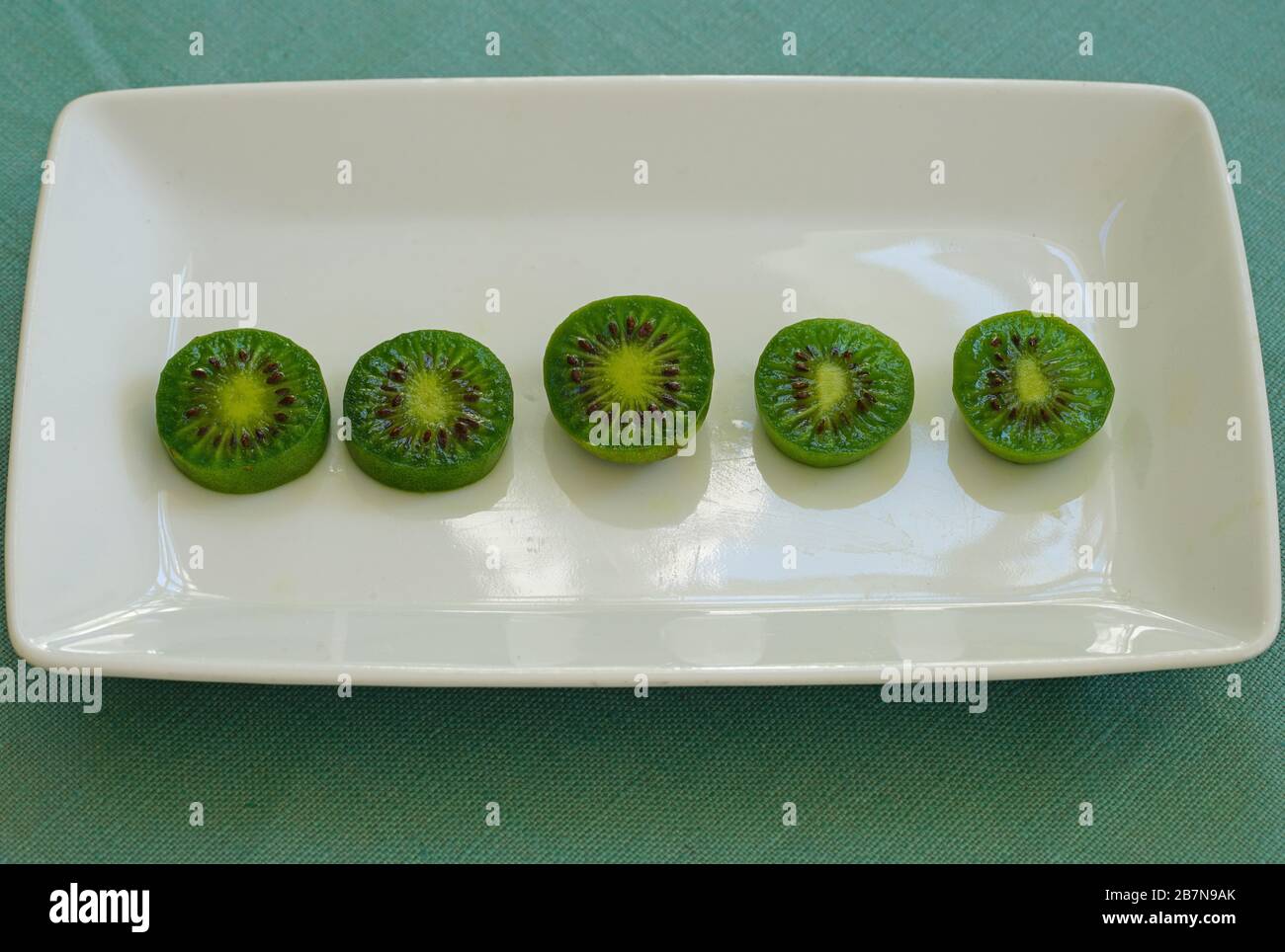 Platter of sliced baby kiwi fruit Stock Photo Alamy