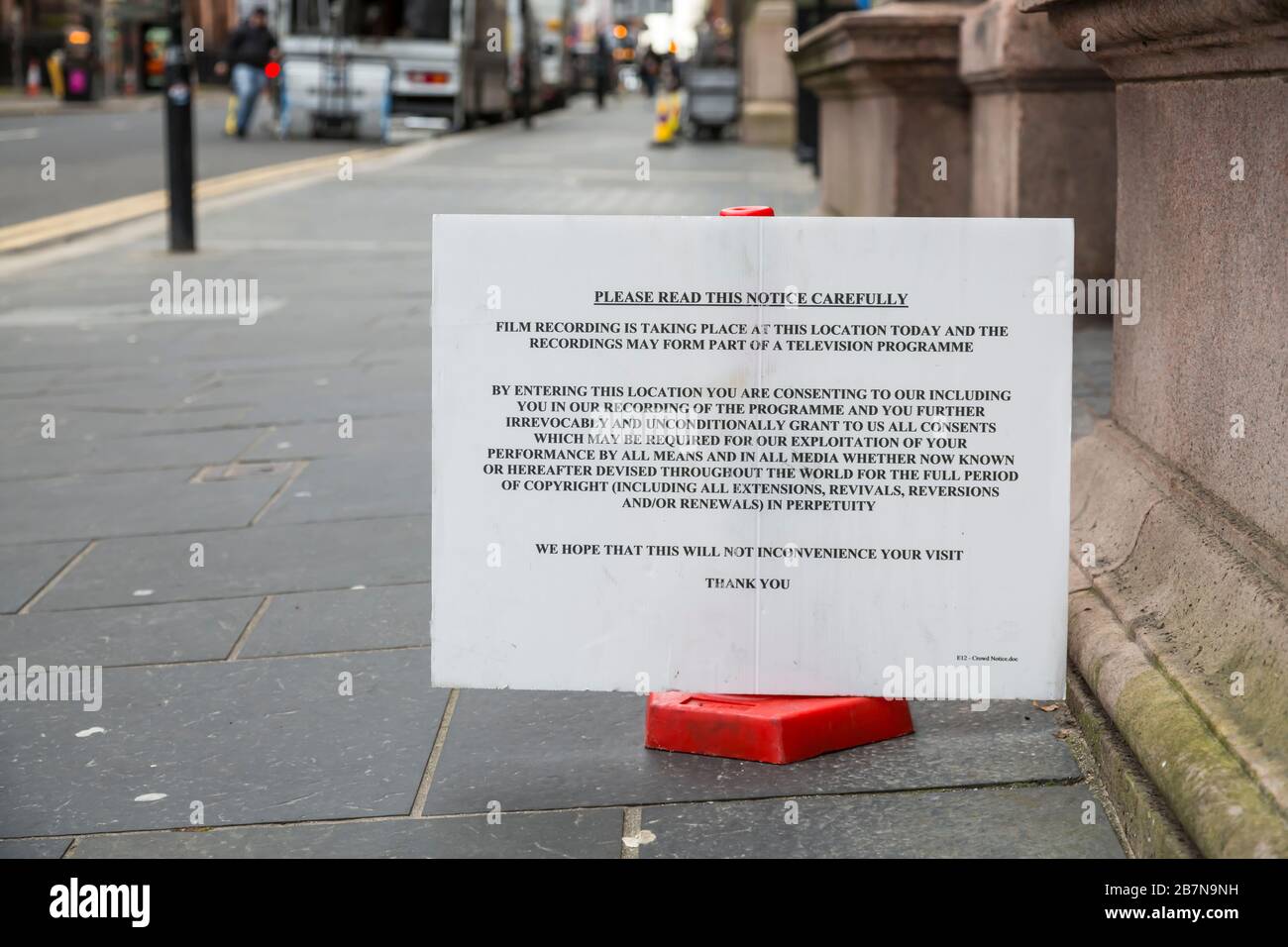 A sign informing pedestrians of filming taking place on a street in Glasgow city centre and consent will be assumed, Scotland, UK Stock Photo