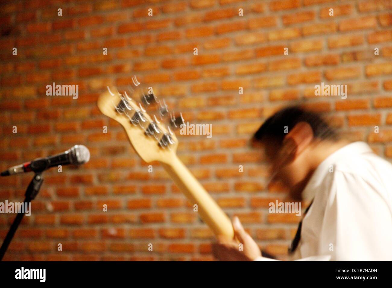 Playing electric guitar on stage. Blurred image. Stock Photo
