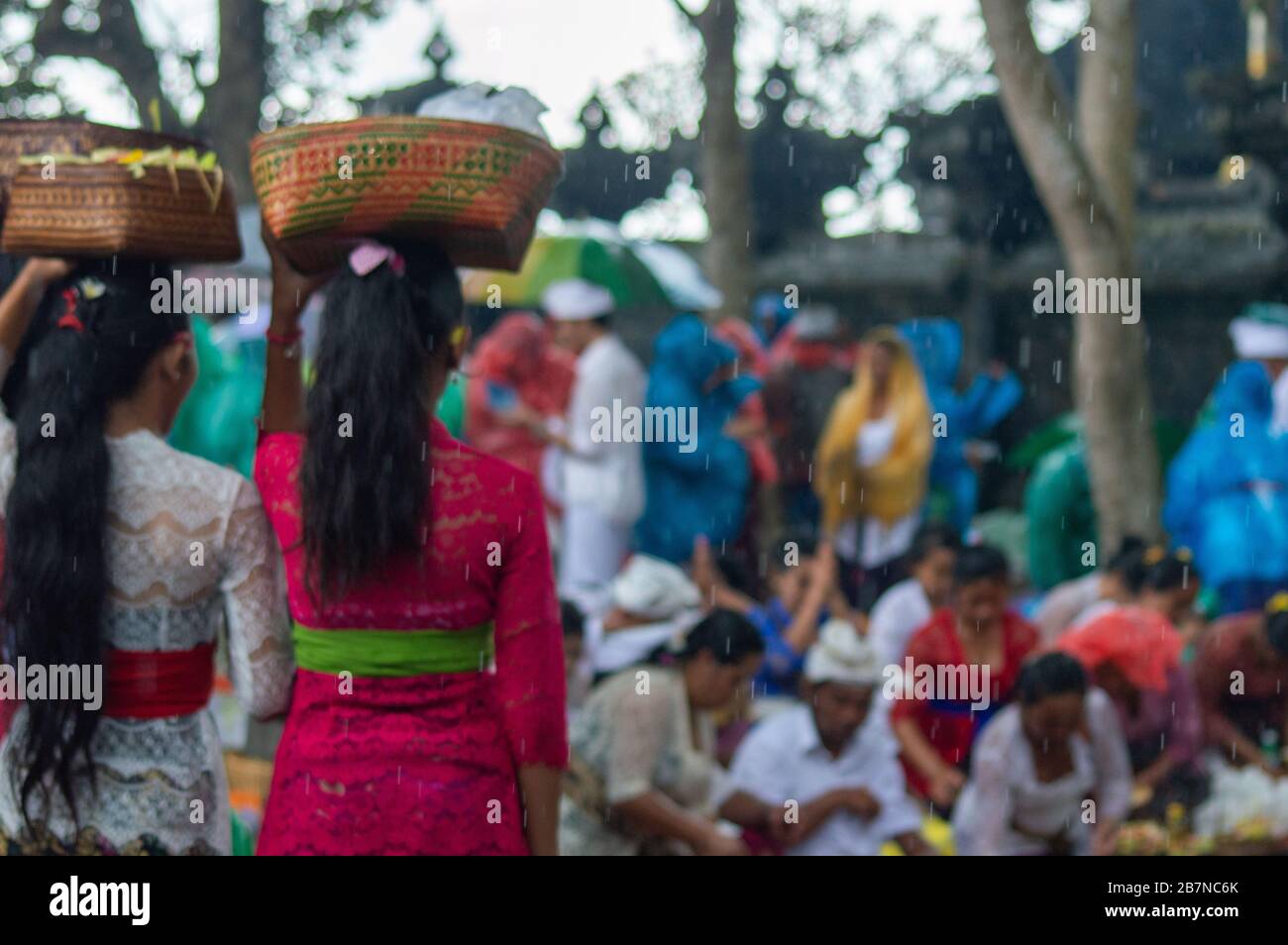 Indonesian women with basket over the head during the holy Celebration at Besakih temple. Bali, Indonesia Stock Photo