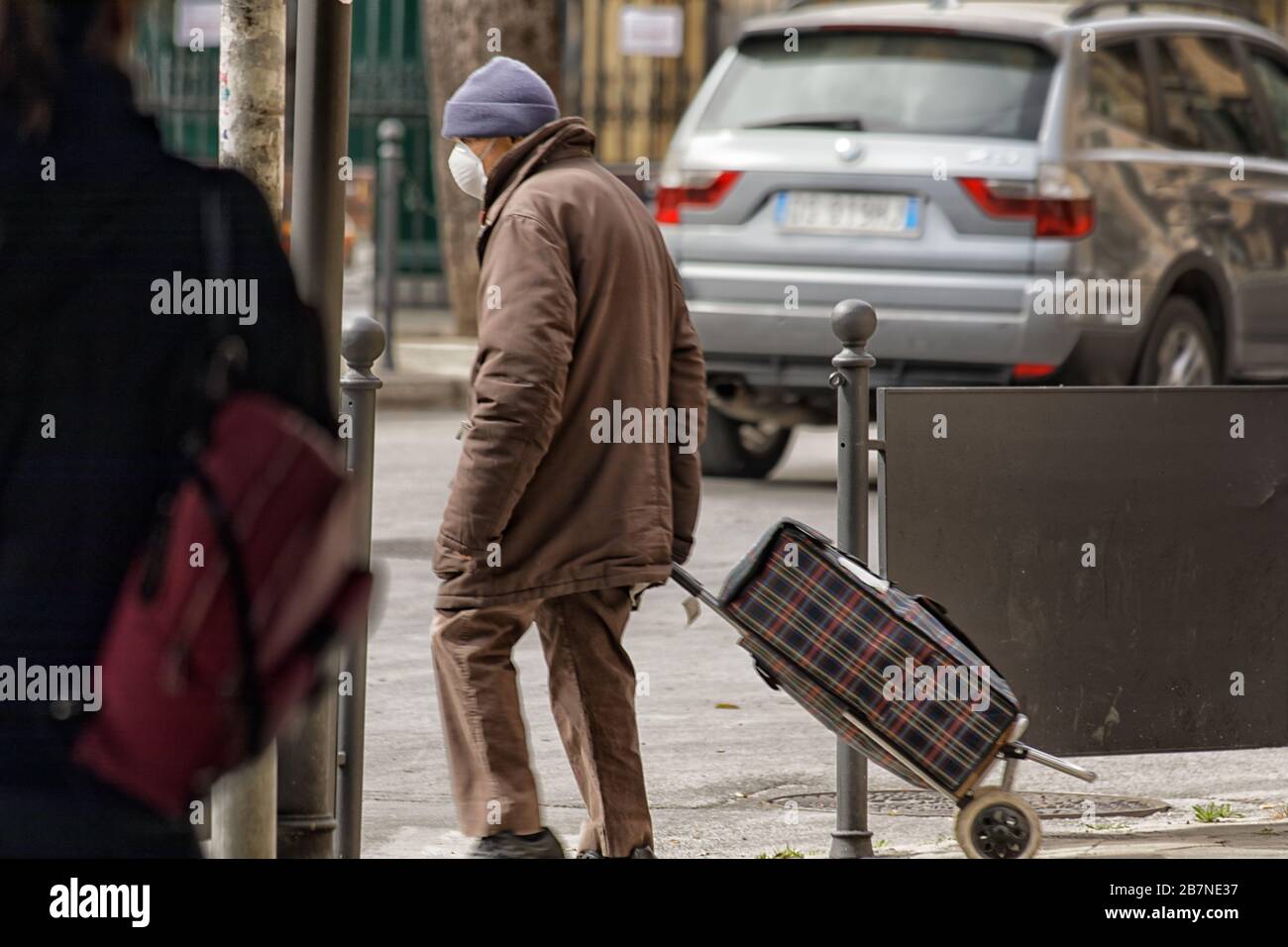 Elderly man with shopping caddie during corona virus pandemic in Palermo, Italy Stock Photo