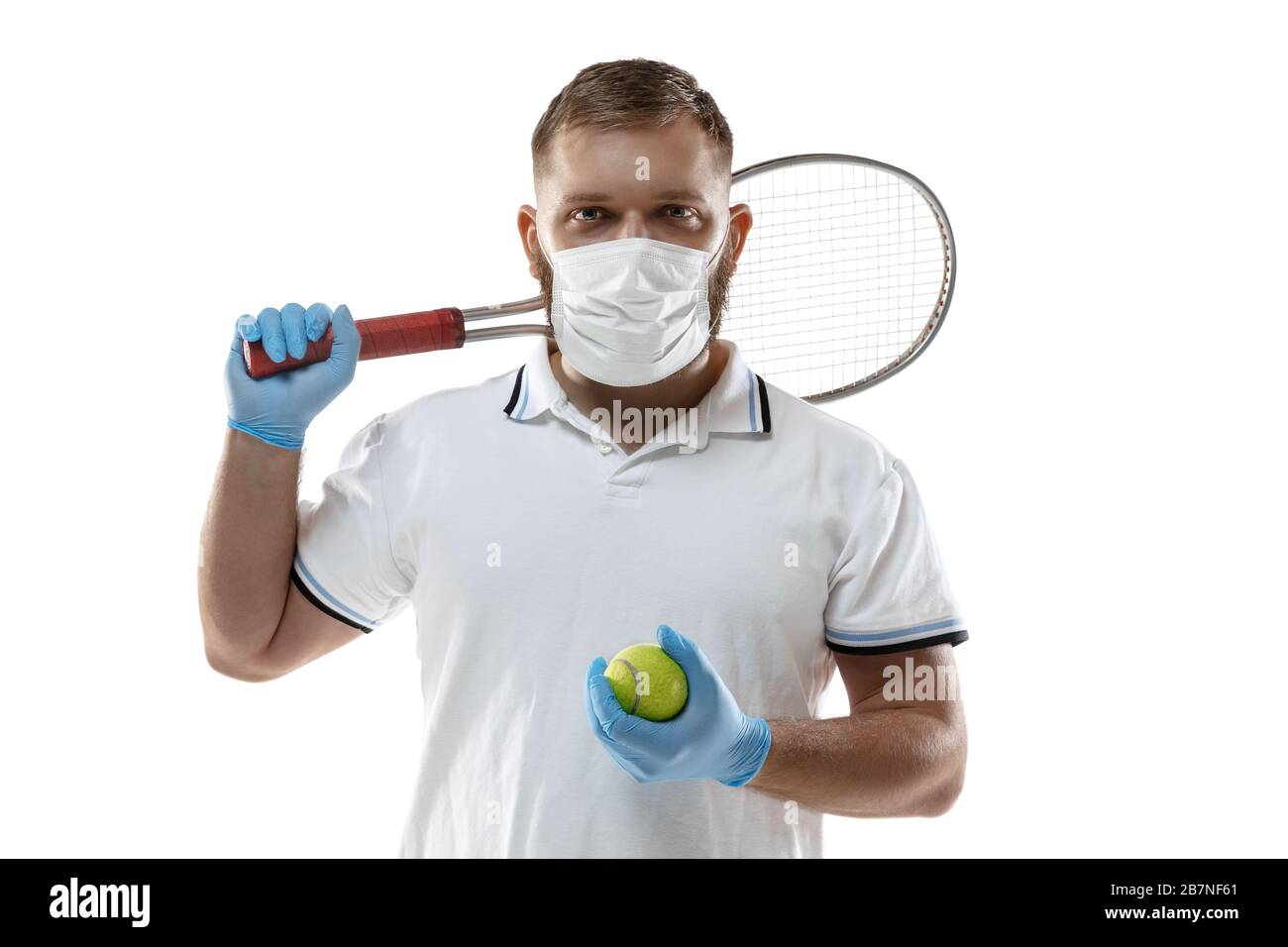 Beat the desease. Tennis player with ball in protective mask