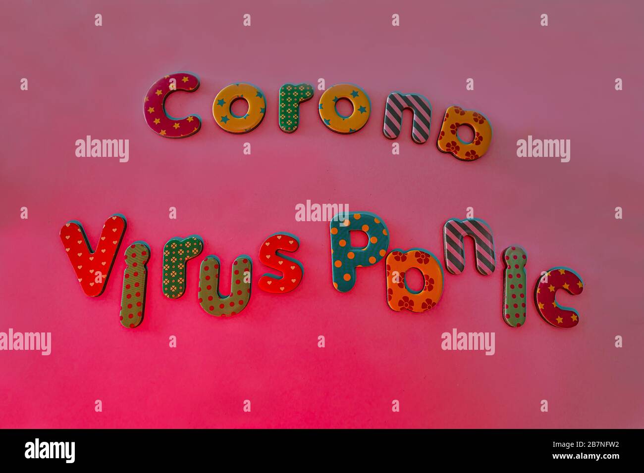 Corona virus panic written bei colored letters as symbol for the global covid-19 fear within pantone background color. Stock Photo