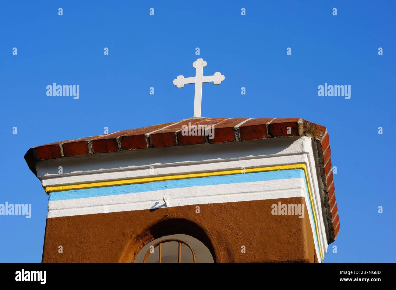 Low angle shot of a church building with a white cross on the roof ...