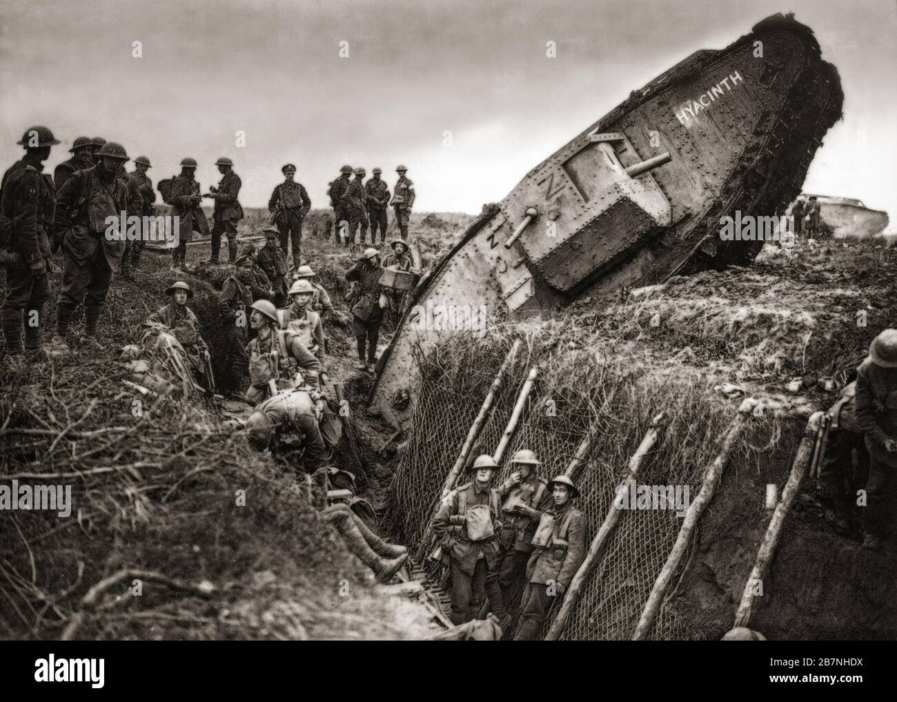 Soldiers from the Leicestershire Regiment gather around a British tank stuck in over-ran German trenches, during the Third Battle of Ypres aka the Battle of Passchendaele, a campaign of the First World War, that took place on the Western Front, from July to November 1917, for control of the ridges south and east of the Belgian city of Ypres in West Flanders. Stock Photo
