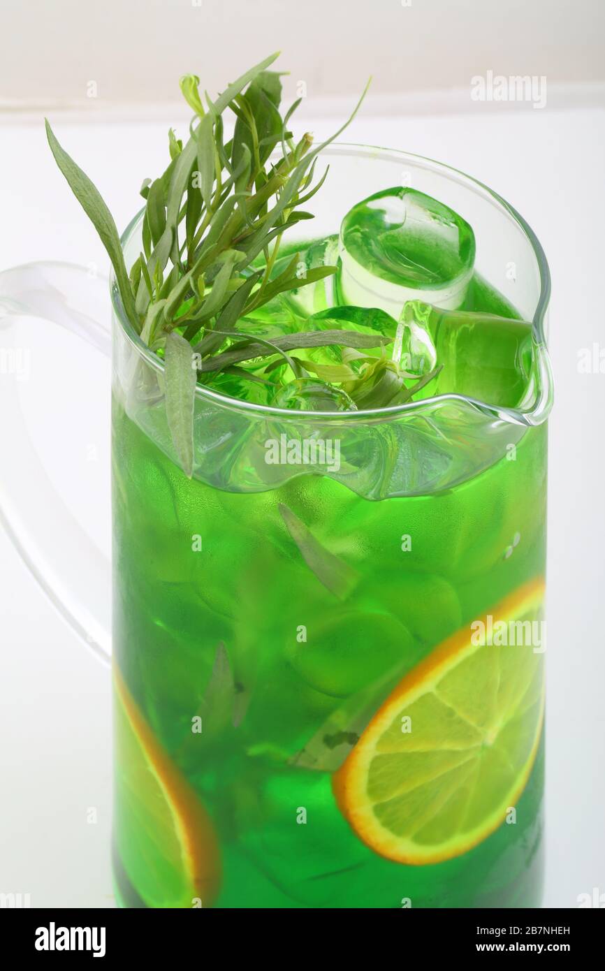 Cocktail with tarragon, orange and ice cubes Stock Photo