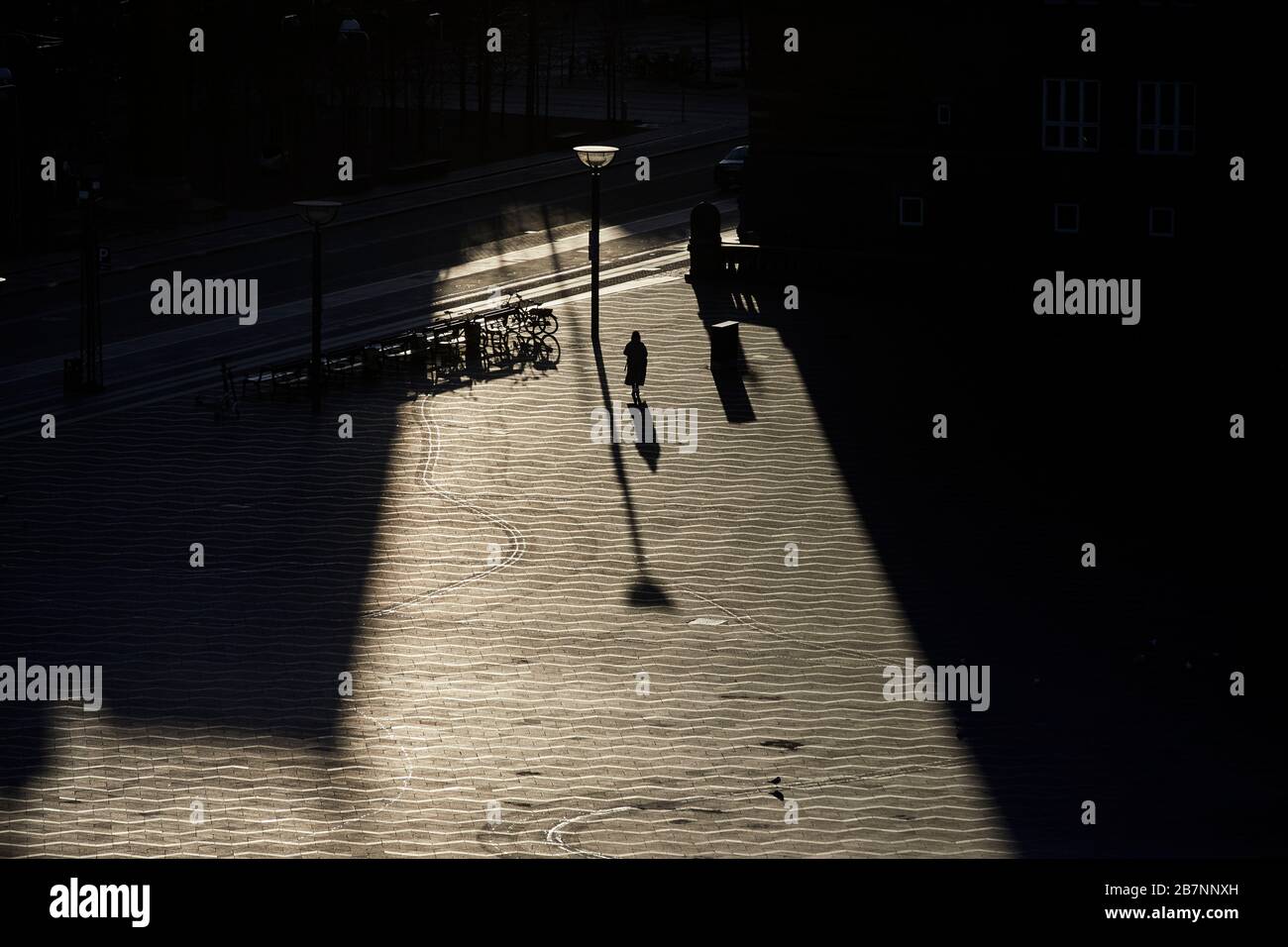 Copenhagen, Denmark’s capital,  long shadows silhouettes over City Hall Square at sunrise Stock Photo