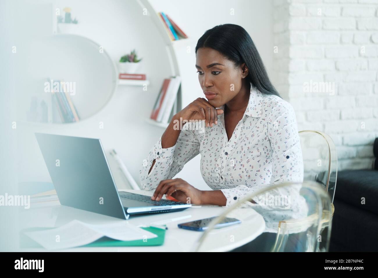 Black Woman Working From Home With Laptop Computer Stock Photo