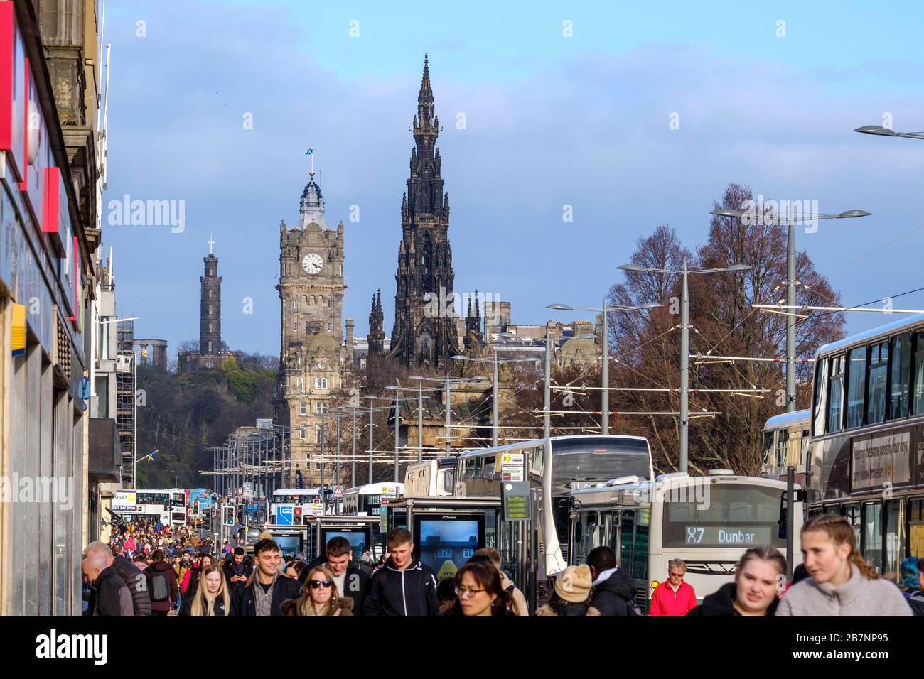 The Nelson Monument, Balmoral Hotel and Scott Monument  tower over shoppers and pedestrians on Princess Street, the main shopping street in Edinburgh city centre. Stock Photo