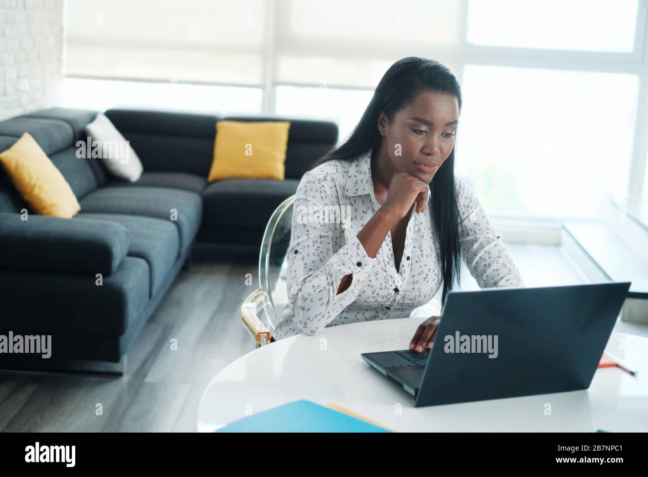 Black Woman Working From Home With Laptop Computer Stock Photo