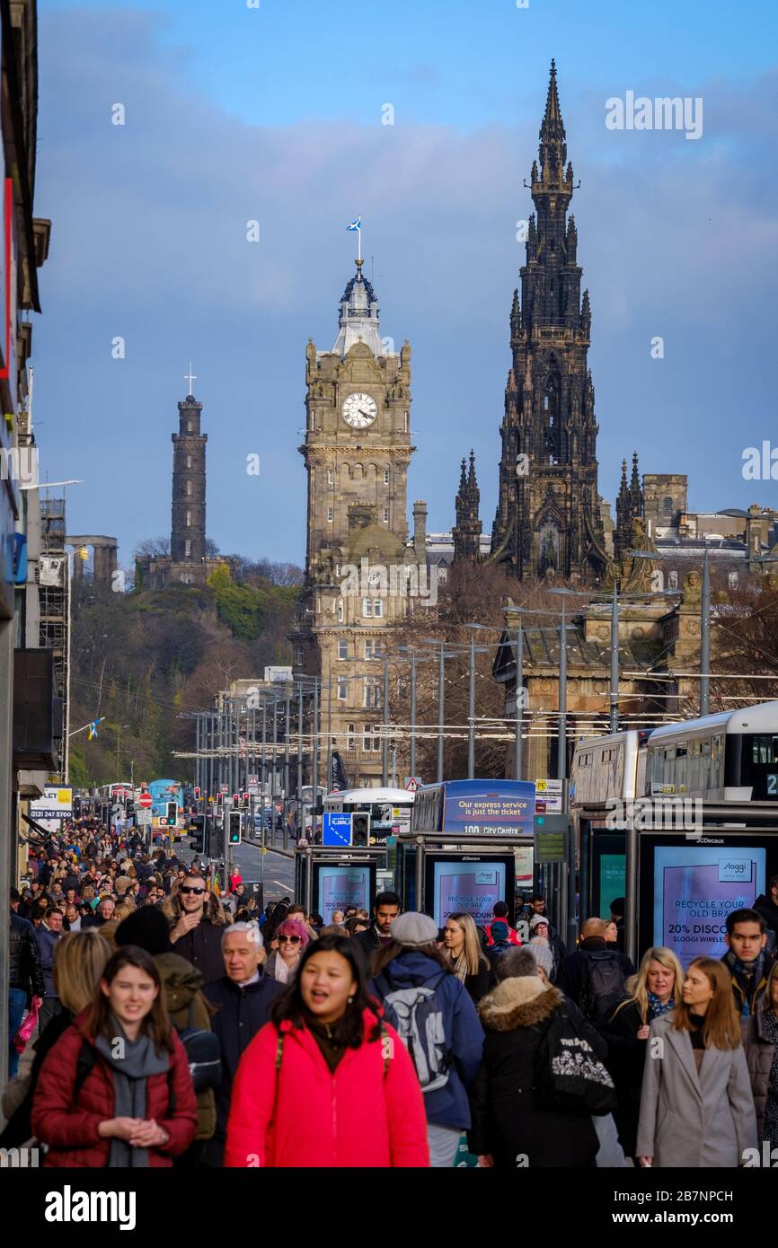 The Nelson Monument, Balmoral Hotel and Scott Monument  tower over shoppers and pedestrians on Princess Street, the main shopping street in Edinburgh city centre. Stock Photo