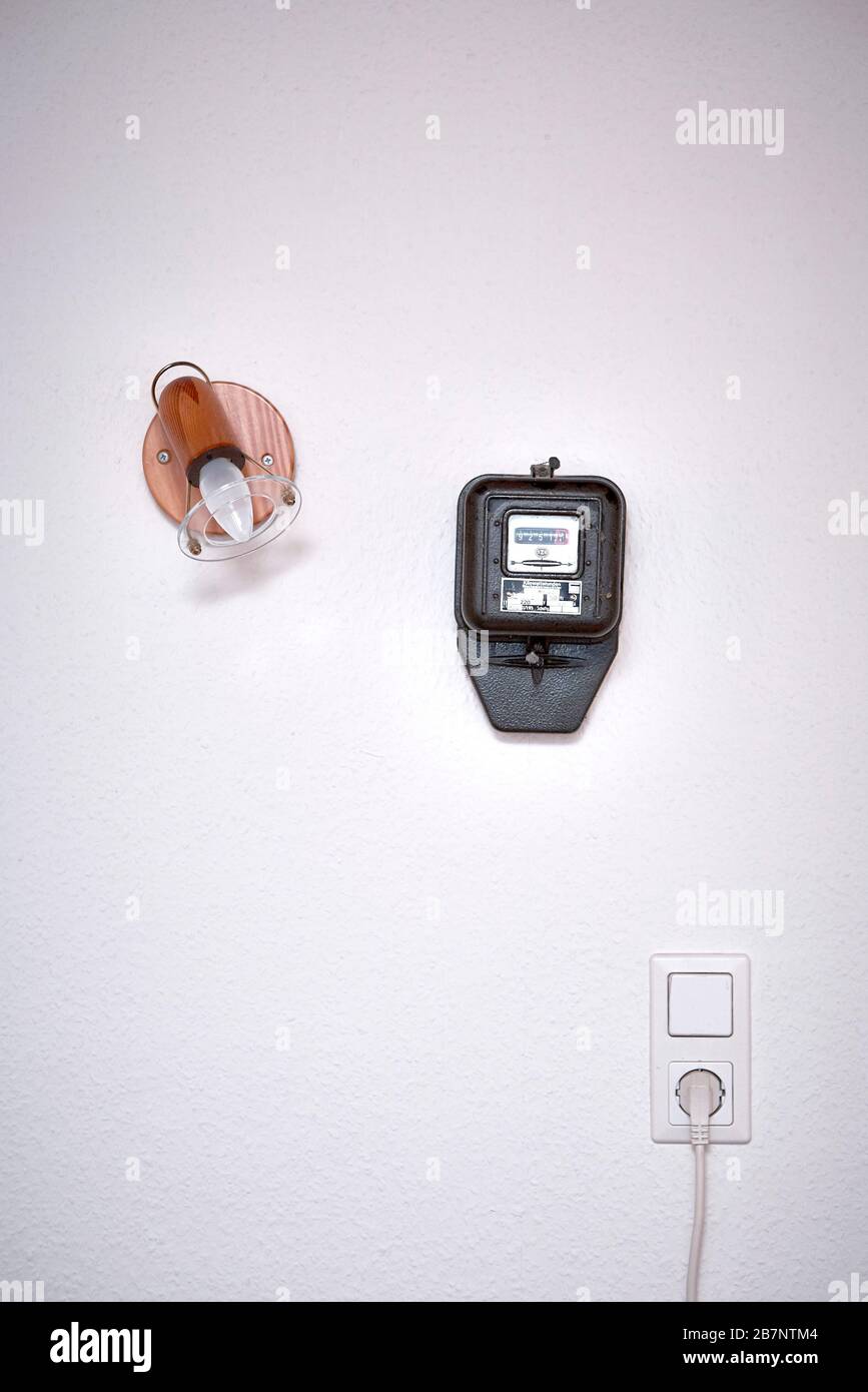 A ugly electrical installation on a wall in a cheap hotel room at the Allgaeu. Stock Photo