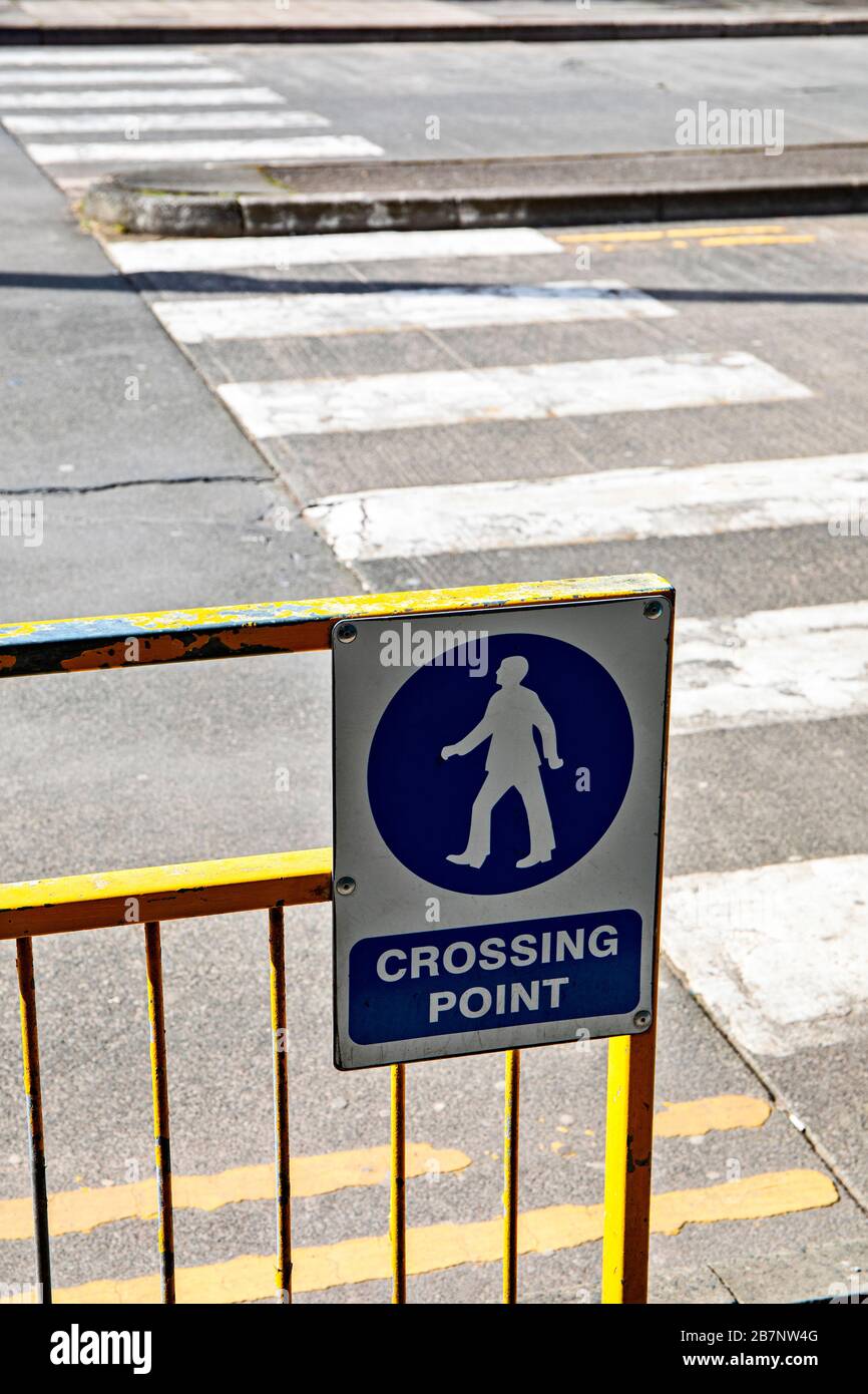 Crossing point sign by zebra crossing UK Stock Photo