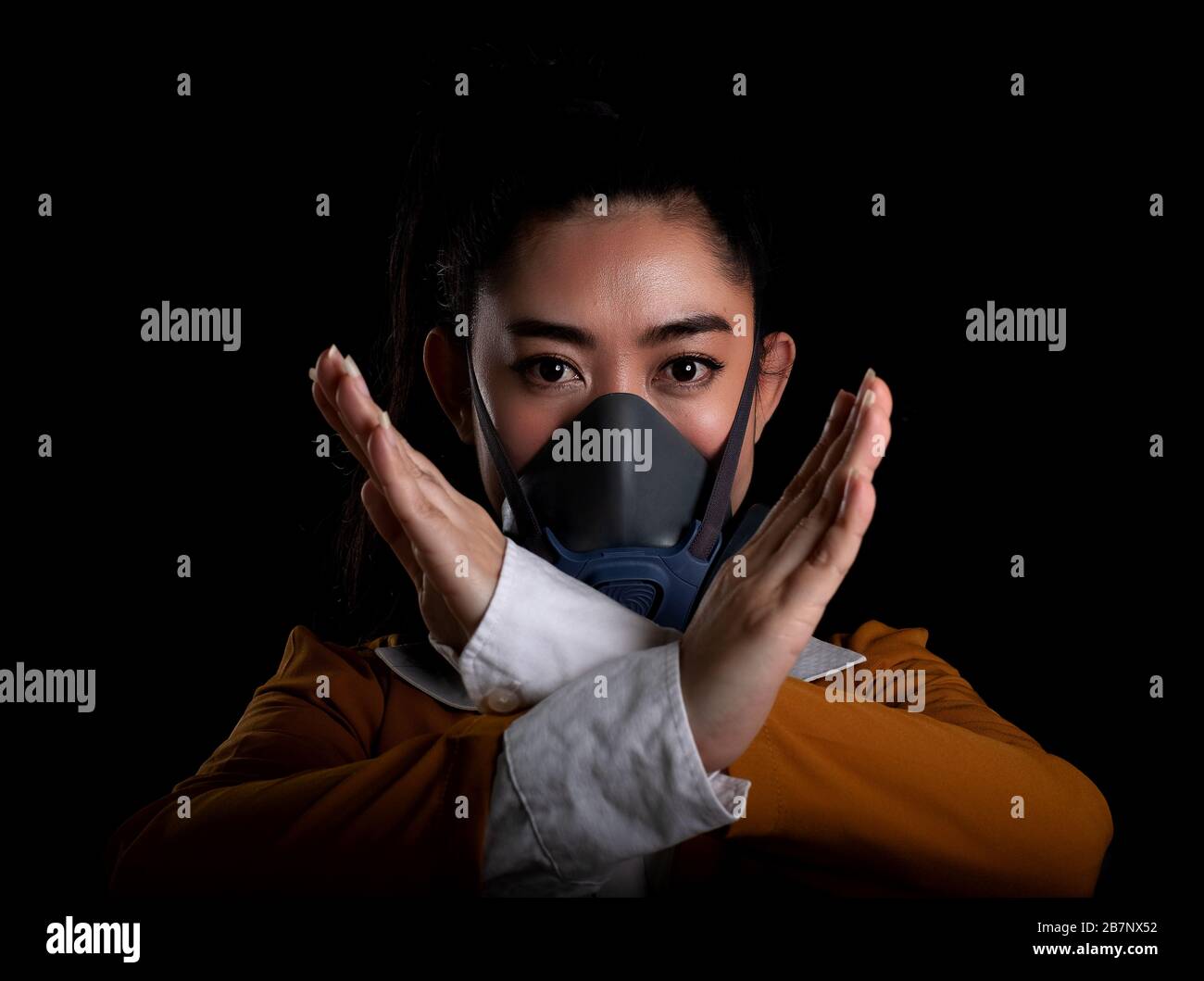 Businesswoman of young Asia woman putting on a respirator N95 mask to ...
