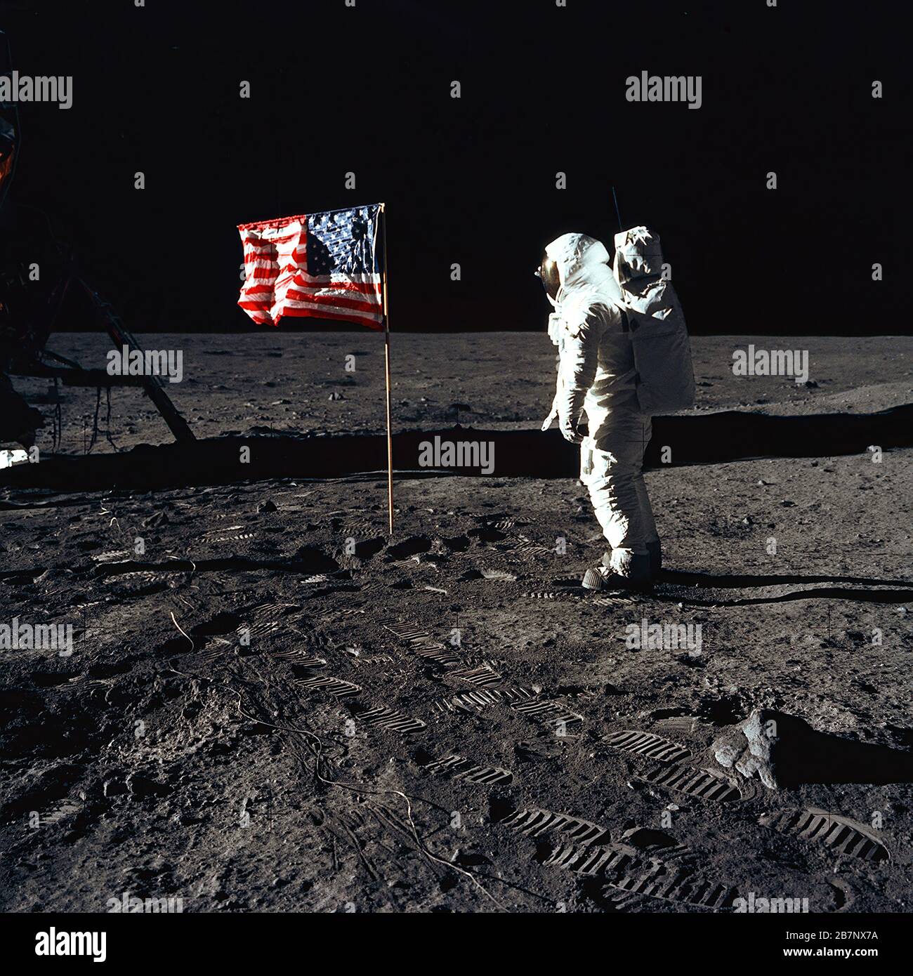 Apollo 11 - NASA, 1969. Astronaut Edwin E. &quot;Buzz&quot; Aldrin, Jr., beside the U.S. flag during an Apollo 11 moon walk. The Lunar Module (LM) is on the left, and the footprints of the astronauts are clearly visible in the soil of the moon. Astronaut Neil A. Armstrong, commander, took this picture with a 70mm Hasselblad lunar surface camera. Stock Photo