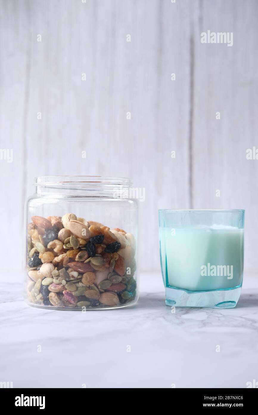 mixed nut , milk on table against white wall Stock Photo Alamy