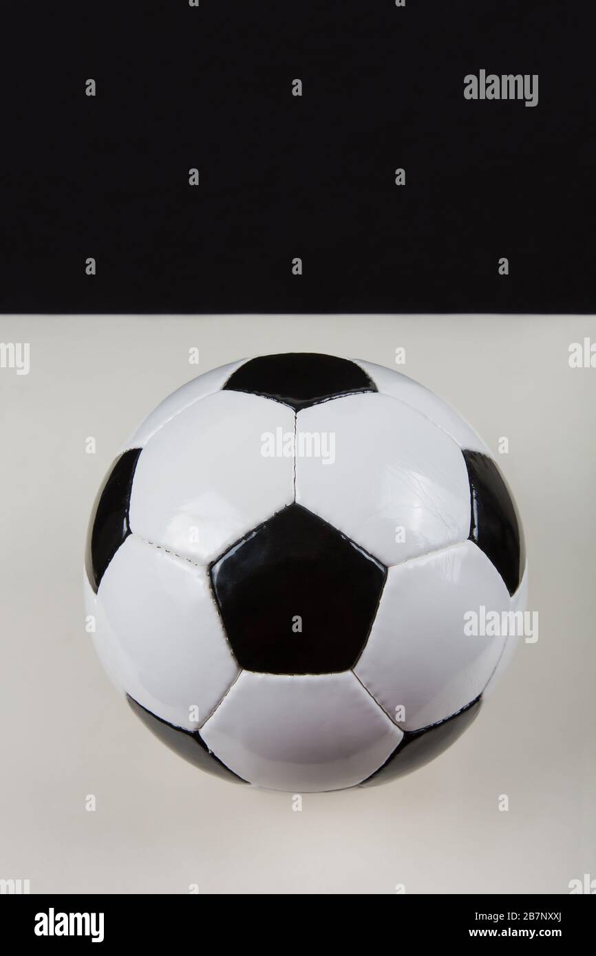 Classic football ball, typical hexagon pattern, isolated on grey table