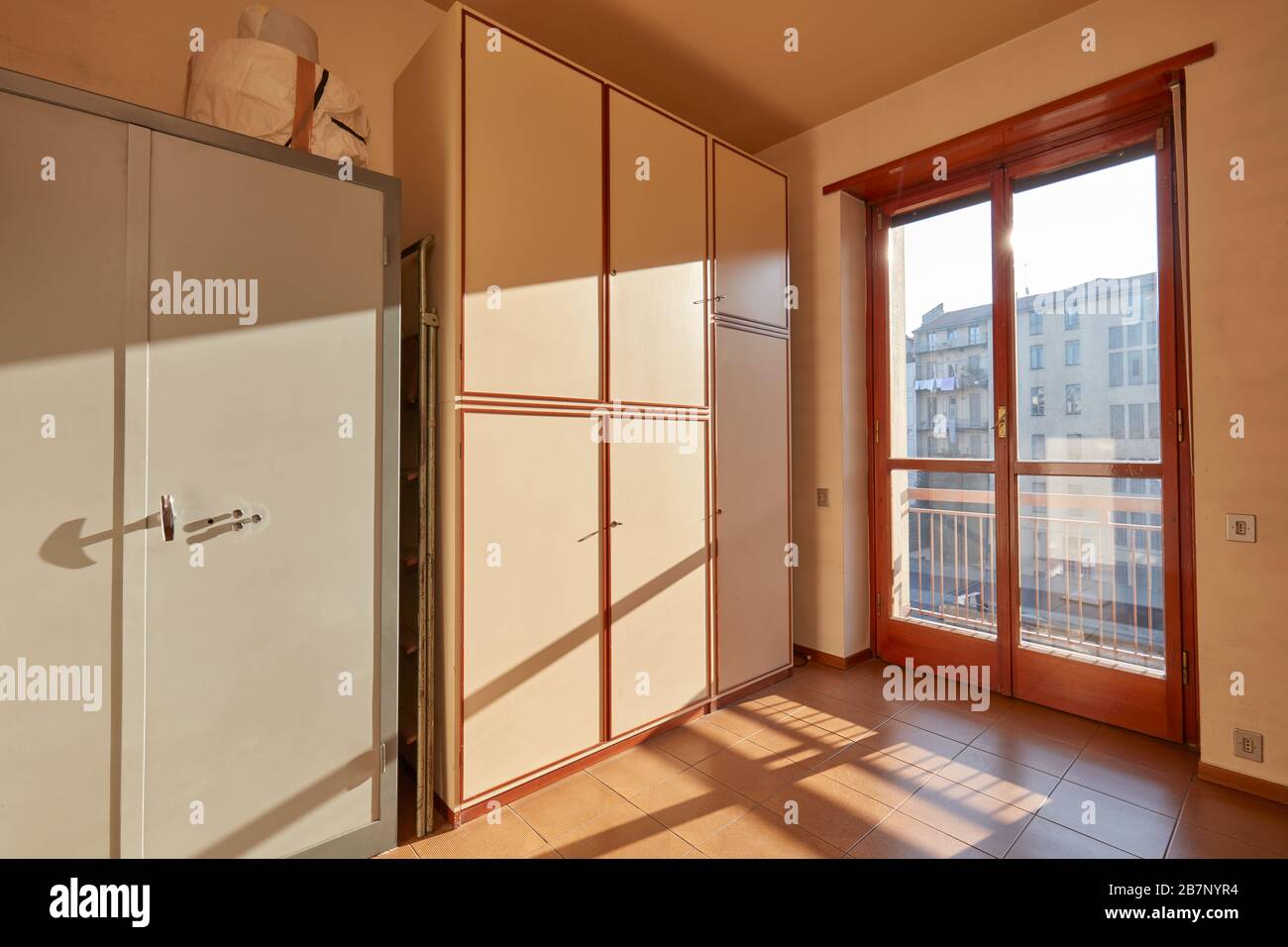 Sunny room with wardrobe and safe in apartment interior Stock Photo